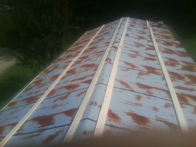 Rusted metal roof panels with new wood purlins before replacement — Storm Damage Roof Repair in Walthourville by Roofing Brothers