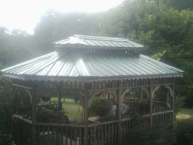 Two tier green metal roof on a garden gazebo in Walthourville